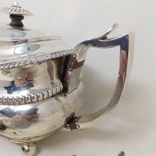 877 - A George III silver teapot, a cut glass match strike, with a silver mount, a silver plated tea strai... 