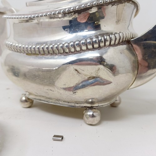 877 - A George III silver teapot, a cut glass match strike, with a silver mount, a silver plated tea strai... 