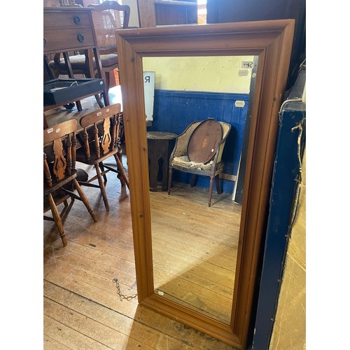 1325 - A pine framed wall mirror, 142 x 61 cm, and another and a painted dumb porter, 92 cm high (3)