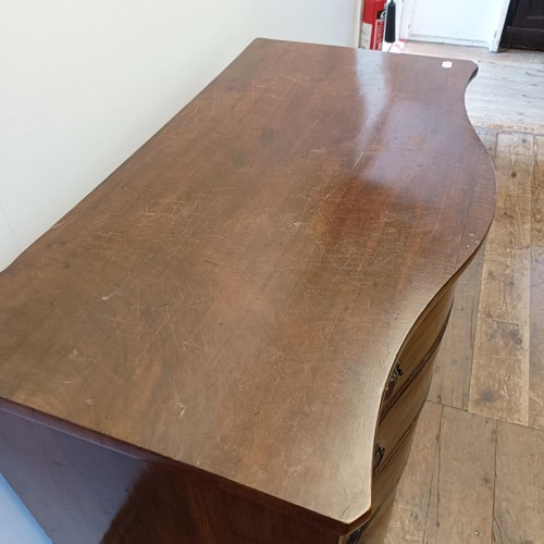 1323 - A 19th century mahogany serpentine front chest, having three long drawers, 118 cm wide