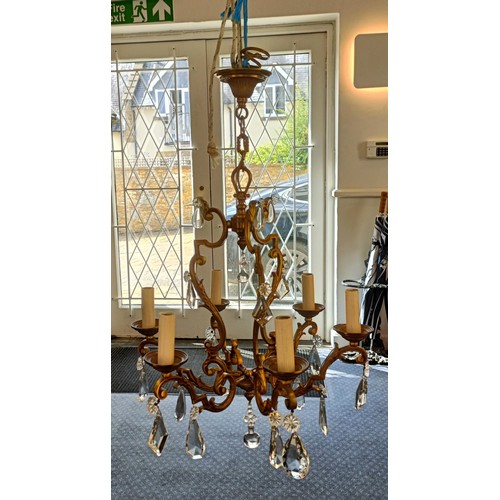 1322 - A brass chandelier, with cut glass drops, 50 cm diameter approx.