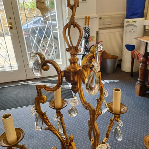 1322 - A brass chandelier, with cut glass drops, 50 cm diameter approx.