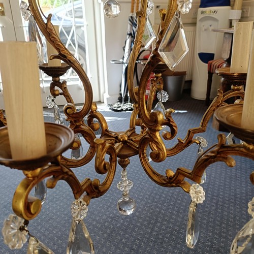 1322 - A brass chandelier, with cut glass drops, 50 cm diameter approx.