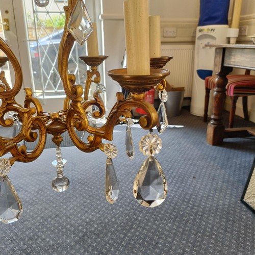 1322 - A brass chandelier, with cut glass drops, 50 cm diameter approx.