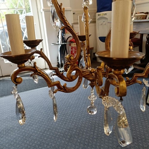 1322 - A brass chandelier, with cut glass drops, 50 cm diameter approx.