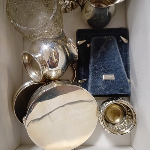 766 - A silver mounted photograph frame, two silver cream jugs and assorted other items