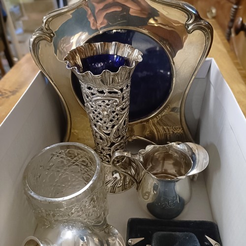 766 - A silver mounted photograph frame, two silver cream jugs and assorted other items
