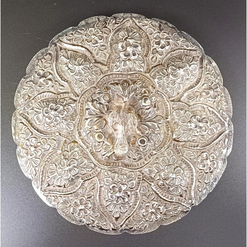 768 - An Indian silver coloured metal hand mirror, 16 cm diameter, another, decorated flowers, 22 cm wide,... 