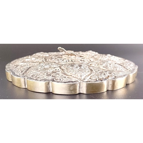 768 - An Indian silver coloured metal hand mirror, 16 cm diameter, another, decorated flowers, 22 cm wide,... 