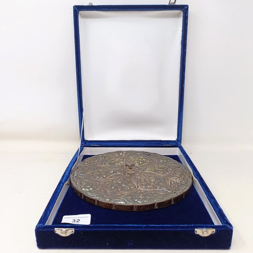 768 - An Indian silver coloured metal hand mirror, 16 cm diameter, another, decorated flowers, 22 cm wide,... 