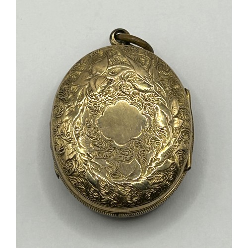 732 - A late 19th/early 20th century yellow metal memorial double locket, inset with two photographs and t... 