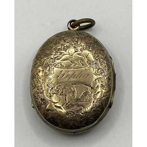 732 - A late 19th/early 20th century yellow metal memorial double locket, inset with two photographs and t... 