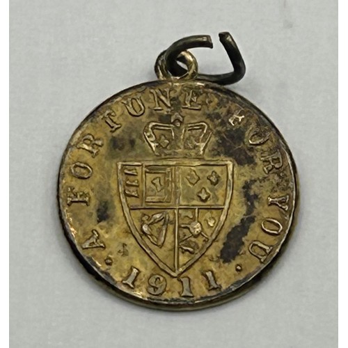 723 - A gold plated token dated 1911, with mount cut, an Art Nouveau gilt metal and enamel buckle, decorat... 