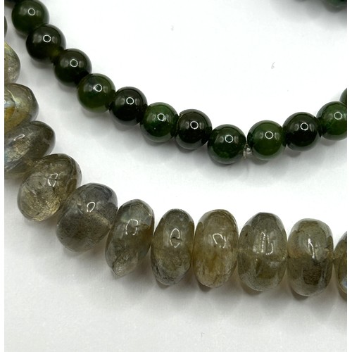 722 - A pair of yellow metal and carved green stone disc earrings, a green stone bead necklace, an opalesc... 
