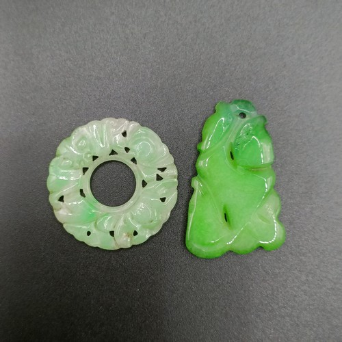 722 - A pair of yellow metal and carved green stone disc earrings, a green stone bead necklace, an opalesc... 