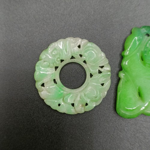722 - A pair of yellow metal and carved green stone disc earrings, a green stone bead necklace, an opalesc... 