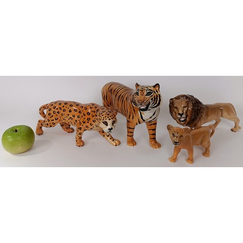 622 - A Beswick figure of a tiger, 28 cm wide and three Beswick figures of big cats (4)