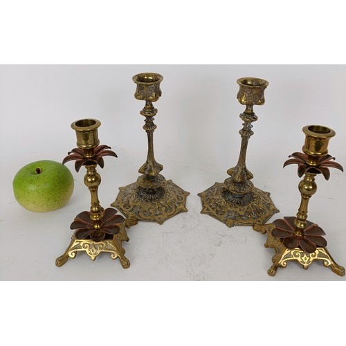 638 - A pair of brass and copper candlesticks 15 cm high, and a pair of brass candlesticks, 20 cm high (4)... 