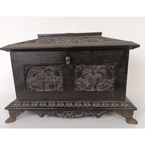 645 - A 19th century Anglo Indian carved ebony box, 30 cm wide