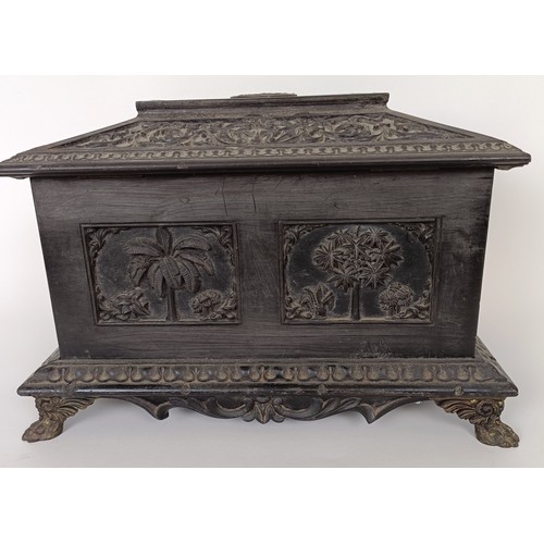645 - A 19th century Anglo Indian carved ebony box, 30 cm wide