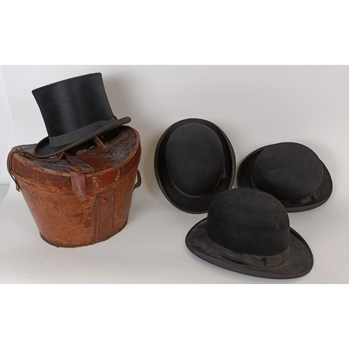 657 - A moleskin top hat, by Christys of London, in a leather carry case and three bowler hats (4)