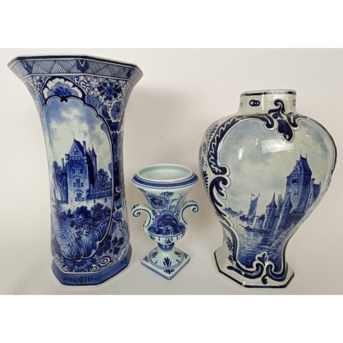 745 - A Delft vase, 33 cm high, another lacking cover, 30 cm high and a Delft vase, 17 cm high (3)