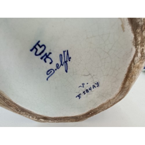 745 - A Delft vase, 33 cm high, another lacking cover, 30 cm high and a Delft vase, 17 cm high (3)