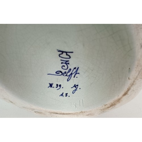 745 - A Delft vase, 33 cm high, another lacking cover, 30 cm high and a Delft vase, 17 cm high (3)