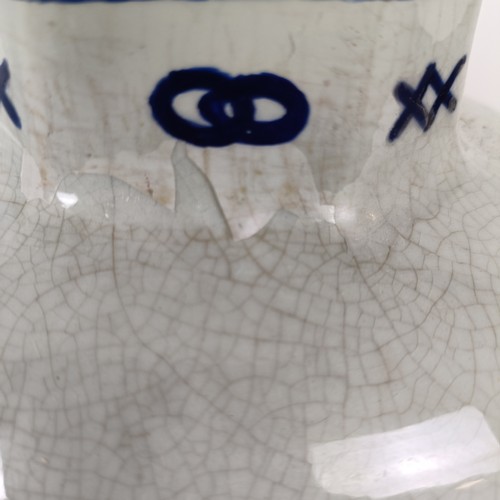 745 - A Delft vase, 33 cm high, another lacking cover, 30 cm high and a Delft vase, 17 cm high (3)