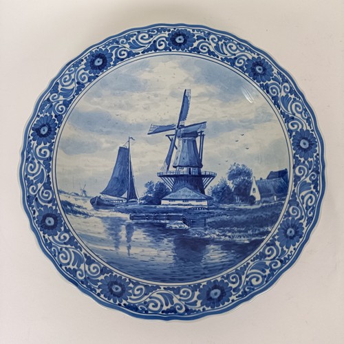 746 - A blue and white Delft plate, decorated windmill, 29 cm diameter, and another decorated peacock, 35 ... 