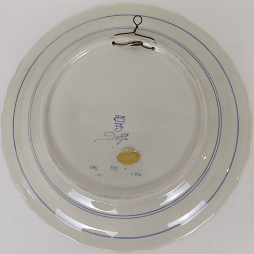 746 - A blue and white Delft plate, decorated windmill, 29 cm diameter, and another decorated peacock, 35 ... 