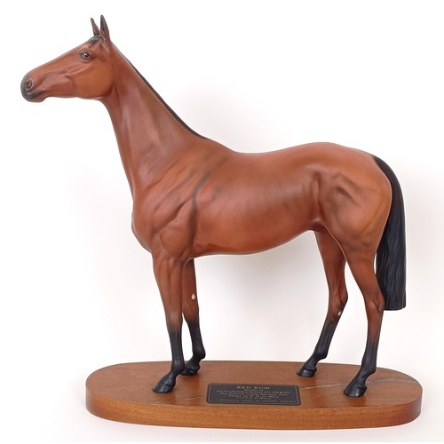 611 - A Beswick figure of Red Rum, on a mahogany base, 31 cm high and three Beswick foal figures (4)