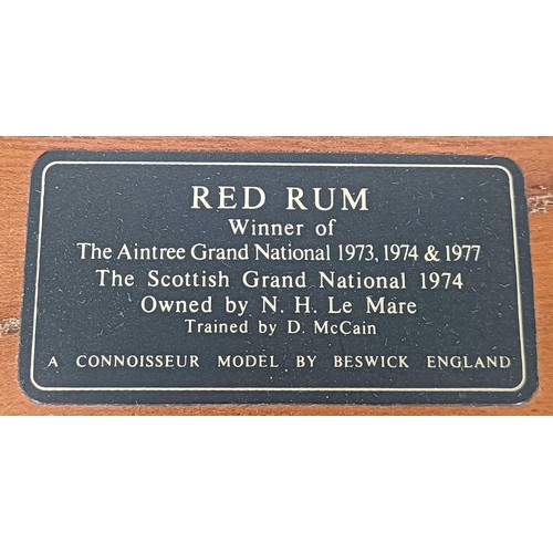 611 - A Beswick figure of Red Rum, on a mahogany base, 31 cm high and three Beswick foal figures (4)