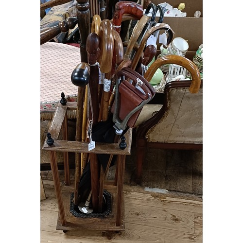 754 - Assorted walking sticks, a stick stand and two prints
