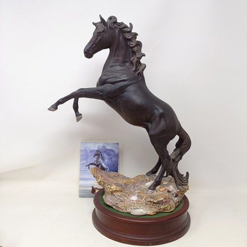 607A - A Beswick figure, Cancara The Black Horse, 40 cm high, a Doulton horse and a figure of a horse (3)