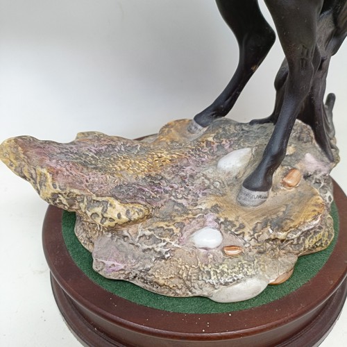 607A - A Beswick figure, Cancara The Black Horse, 40 cm high, a Doulton horse and a figure of a horse (3)