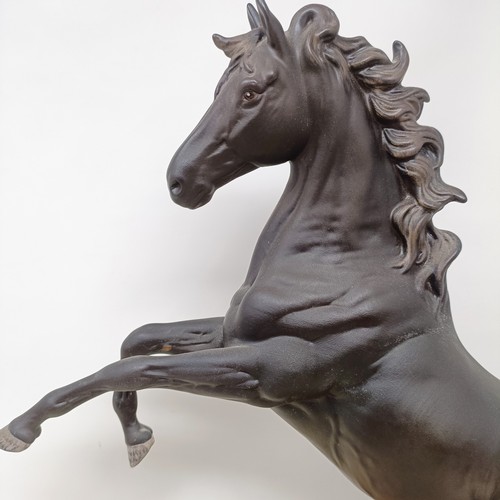 607A - A Beswick figure, Cancara The Black Horse, 40 cm high, a Doulton horse and a figure of a horse (3)