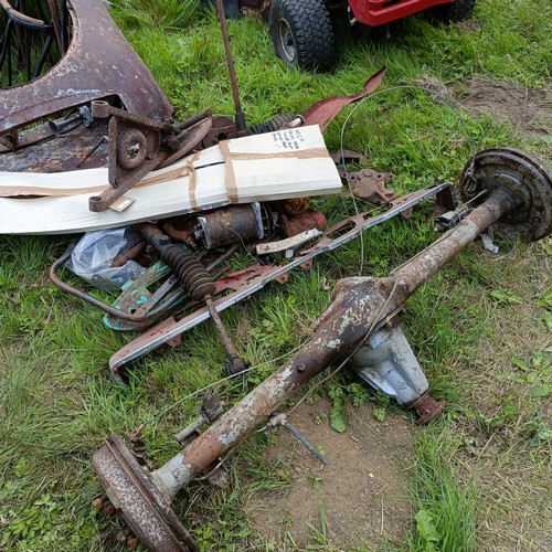 A group of MGA parts, including a rear axle, two dashes, body parts and ...
