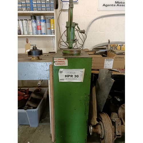 158 - A green painted forecourt oil dispenser, with contents of oil