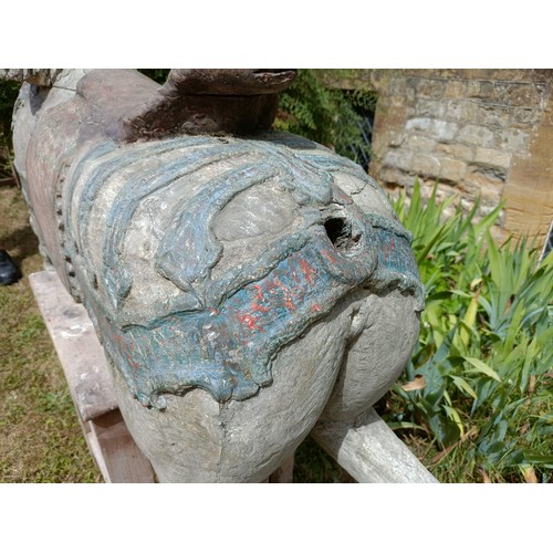 619 - A large and impressive carved wood and painted carousel horse, on a later stand, 190 cm wide