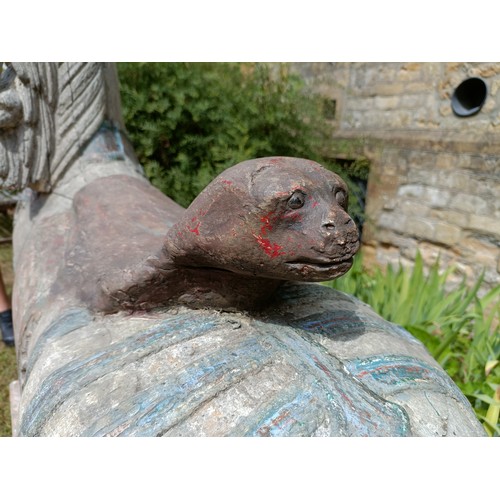 619 - A large and impressive carved wood and painted carousel horse, on a later stand, 190 cm wide