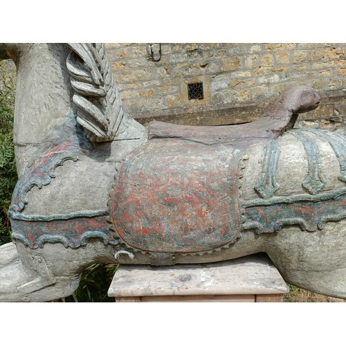619 - A large and impressive carved wood and painted carousel horse, on a later stand, 190 cm wide