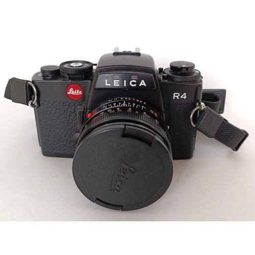 302 - A Leica R4 camera, serial number 1662824, with a Leica lens