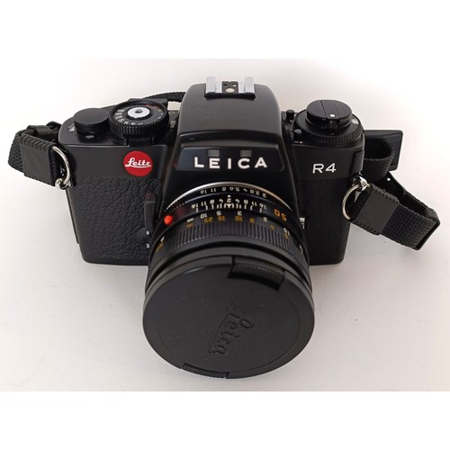 302 - A Leica R4 camera, serial number 1662824, with a Leica lens