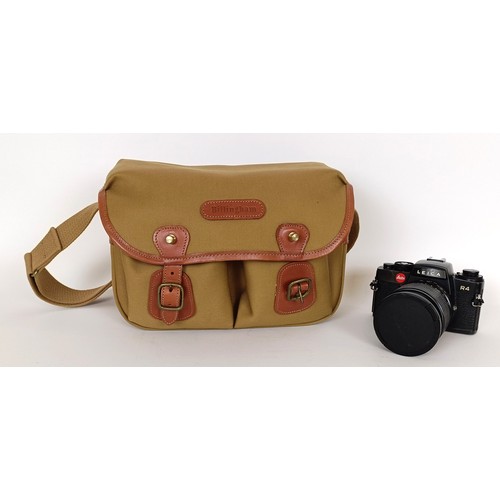 301 - A Leica R4 camera, serial number 1577161, with a Leica lens and a camera bag