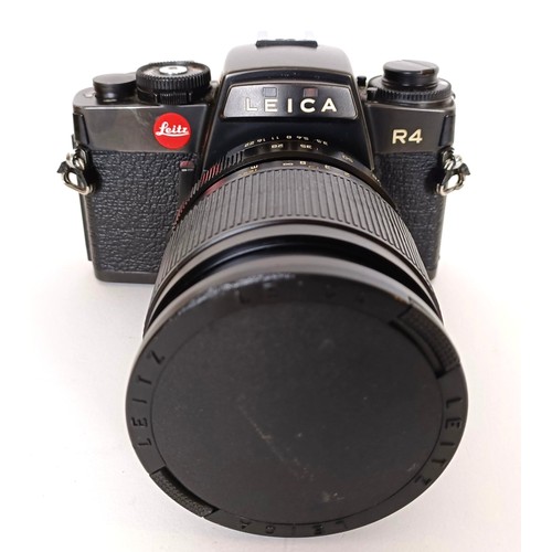 301 - A Leica R4 camera, serial number 1577161, with a Leica lens and a camera bag