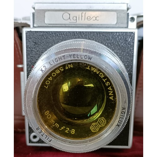 309 - An Agiflex camera and assorted other photographic equipment, in a suitcase