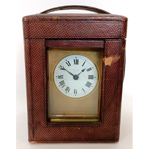 311 - A carriage clock, with an eight day movement, striking on a chime, 17 cm high, in a leather travel c... 