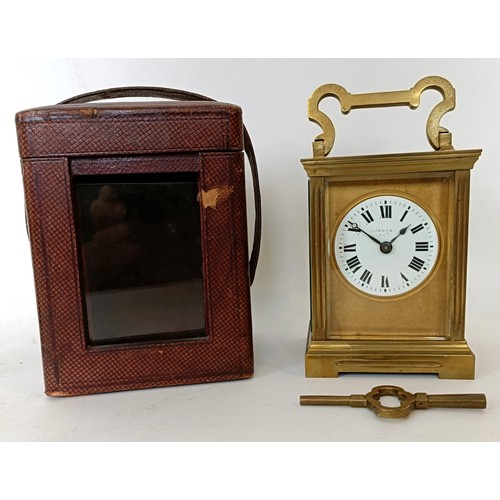 311 - A carriage clock, with an eight day movement, striking on a chime, 17 cm high, in a leather travel c... 
