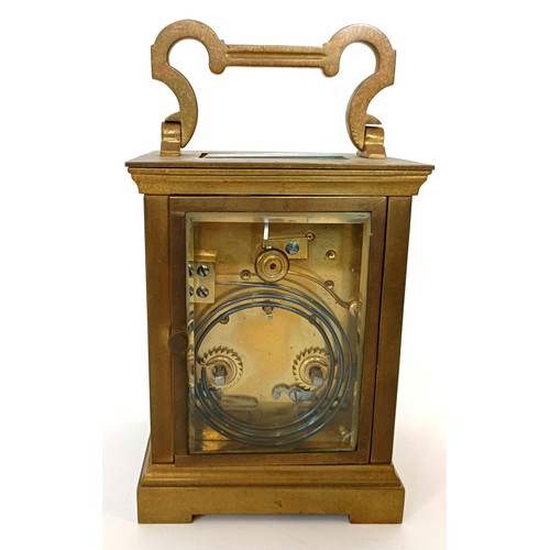 311 - A carriage clock, with an eight day movement, striking on a chime, 17 cm high, in a leather travel c... 